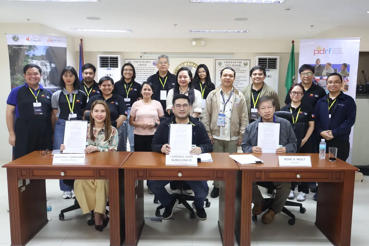 PDRF Executive Director Veronica Gabaldon, Antipolo City Councilor Lorenzo Juan Sumulong III and PDRF President Rene S. Meily hold the signed Memorandum of Agreement, with the project team behind them.