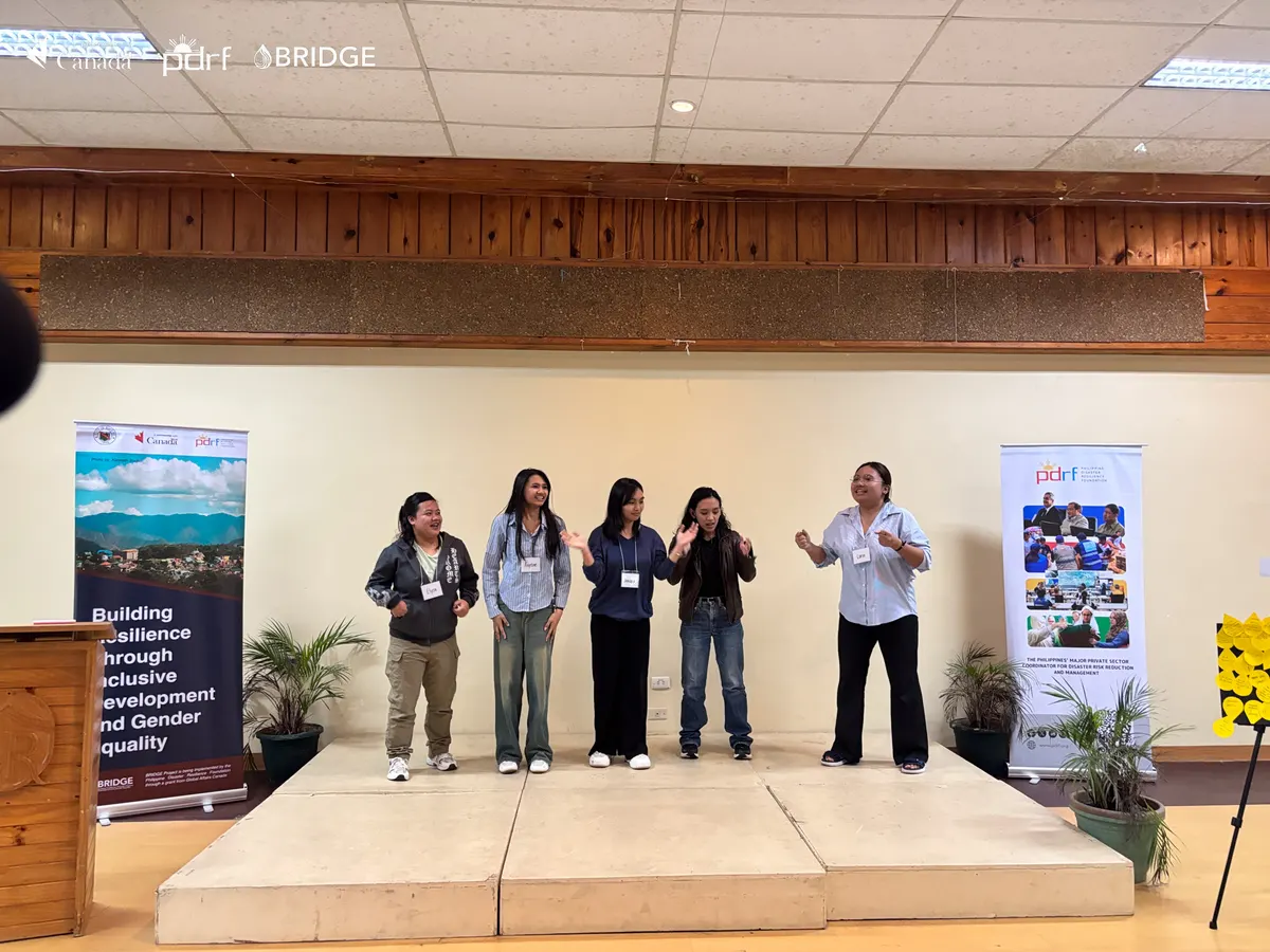 Young women leaders work together on a resilience activity.
