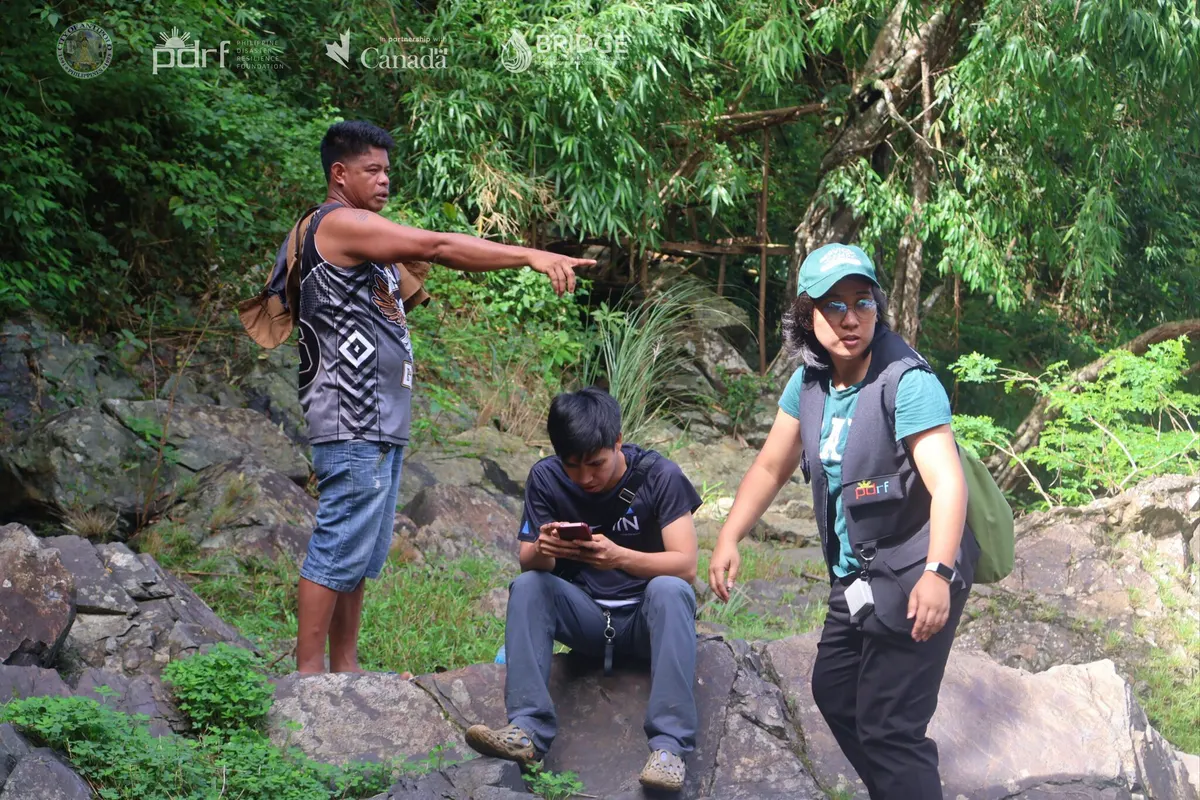 Community members and project staff document a site during field validation.